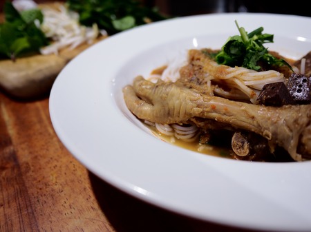 Good food good health, The picture of rice noodles in chicken feet and fish soup on white plate...