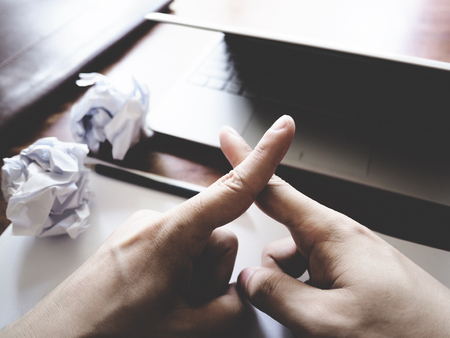 Businesses have both been successful and fail. The picture of paper, pencil, laptop, and hand gesture above wooden table.  selective focusの写真素材