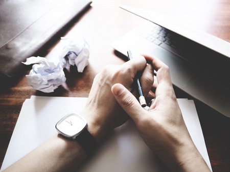Businesses have both been successful and fail. The picture of paper, pencil, laptop, and hand...