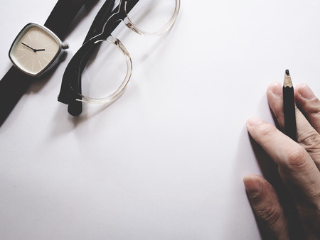 This is office equipment in minimal style, The picture of pen, glasses and watch on white...