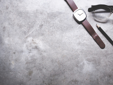 This is office equipment in minimal style, The picture of pencil, glasses and watch on cement background. soft tone color,  minimal styleの写真素材