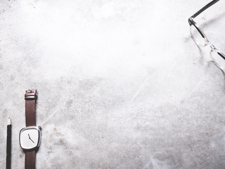 This is office equipment in minimal style, The picture of pencil, glasses and watch on cement background. soft tone color,  minimal styleの写真素材