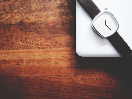 Top view picture of white laptop and watch in minimal style above old wooden background.  soft tone colorの写真素材