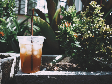 This is a cup of iced lemon tea on tree  background.の写真素材
