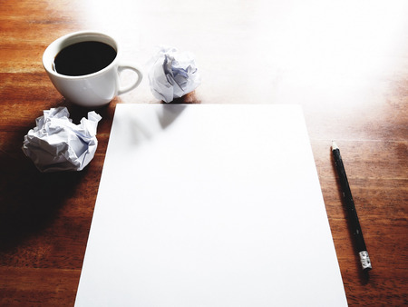 Businesses have both been successful and fail. The picture of fail work, paper, pencil and a cup of coffee above old  wooden table.の写真素材
