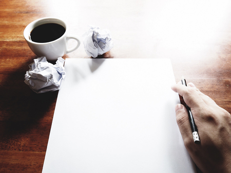 Businesses have both been successful and fail. The picture of fail work, paper, pencil, a cup of coffee  and men hand gesture above old wooden table.の写真素材
