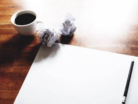 Businesses have both been successful and fail. The picture of fail work, paper, pencil and a cup of coffee above old  wooden table.の写真素材