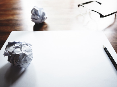This is the failed work action on old wooden table, consist of paper, glasses and pencil.  soft tone styleの写真素材