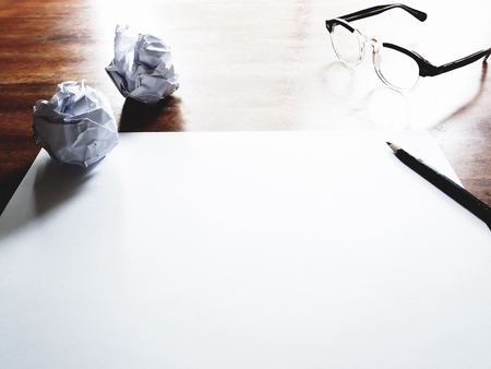 This is the failed work action on old wooden table, consist of paper, glasses and pencil.  soft tone styleの写真素材