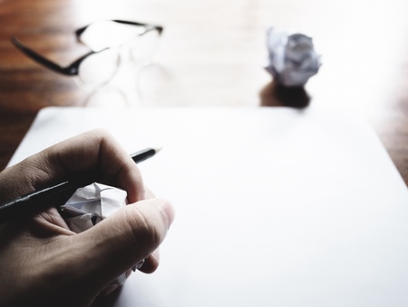 This is the failed work action on old wooden table, consist of paper, glasses and pencil.  soft tone styleの写真素材