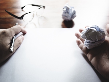 This is the failed work action on old wooden table, consist of paper, glasses and pencil.  soft tone styleの写真素材