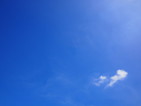 White cloud on the blue sky with a little sun light flare.の写真素材