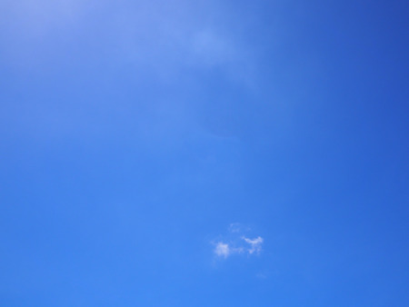 White cloud on the blue sky with a little sun light flare.の写真素材
