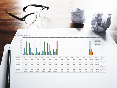 The picture of expense trends graph on workspace background. Financial management conceptの写真素材