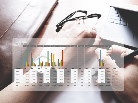 The picture of expense trends graph on workspace background. Financial management conceptの写真素材