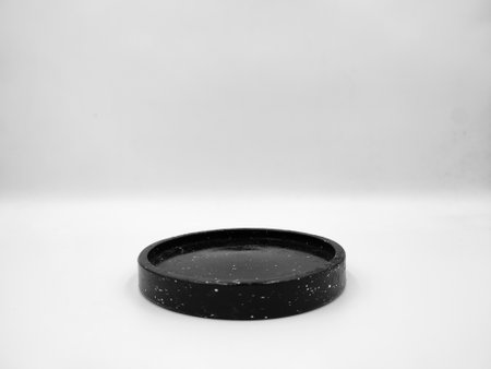Black drink coaster isolated on white backgroundの写真素材