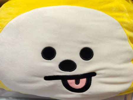 Funny smiling expression with tongue out on doll face closeup viewの写真素材