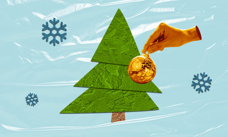 Holiday Decoration Christmas Tree Collage - cut out green tree paper, hand decorating golden ornament, and blue snowflakes, set against a  frosty winter background.の写真素材