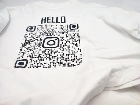 White shirt with QR code for scan printed on it and text Hello. Digital link integrated on product merchandise.の写真素材
