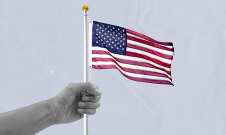 Hand holding USA flag collage illustration. United states of America, symbol of freedom and democracy. American independence day banner.の写真素材