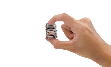 Hand holding stacks of coin isolated, symbol of economy and finance.の写真素材