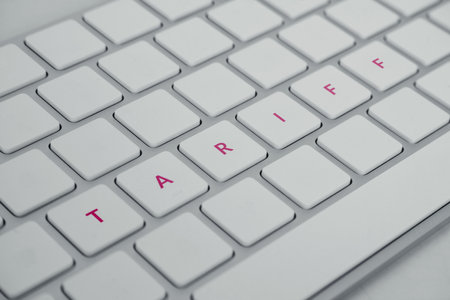 Keyboard spelling word TARIFF. Import tax by national government. Ongoing trade war between superpower countriesの写真素材