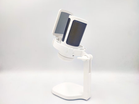 White microphone with pop filter on a desktop stand isolated in white background. Studio photoshoot for electronic product display, back viewの写真素材