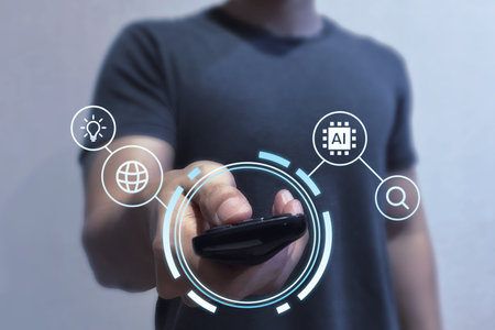 Man holding remote control with futuristic AI interface icons. Artificial intelligence technology for smart home. Augmented reality concept collage.の写真素材