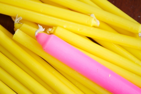 Group of Yellow candle and a pink candle with white candlewickの写真素材