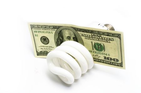 Compact fluorescent light bulbs and US Currency isolated on whiteの写真素材