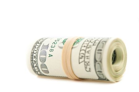 Close up of roll of $100 bills.