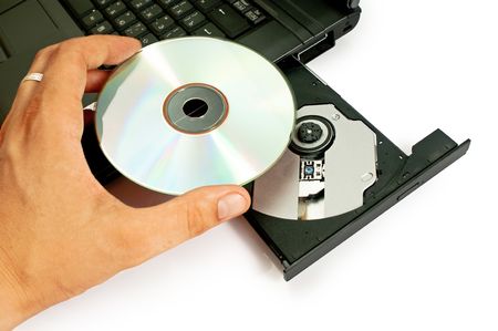 Inserting a CD/DVD into a computer.