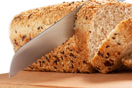 Fresh bread and knife isolated over white