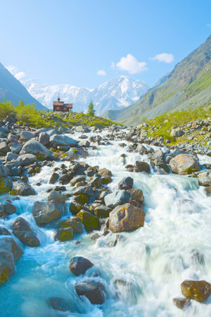 Chapel on the background of snowy peaks, Belukha, Altai Mountains, Siberia, Russiaの写真素材