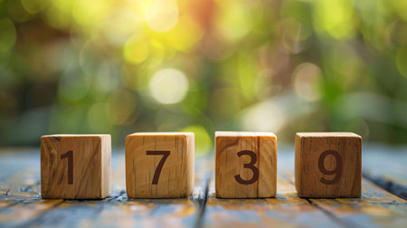 Number of days to go on wooden cubes with bokeh backgroundの素材