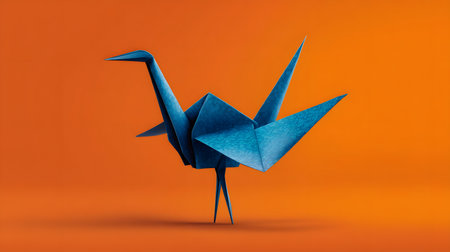 Origami Bird in Blue with Copy Space on Orange Backgroundの素材