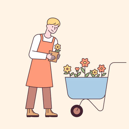 A man in an apron carries flowers in a cart. flat design style minimal vector illustration.のイラスト素材