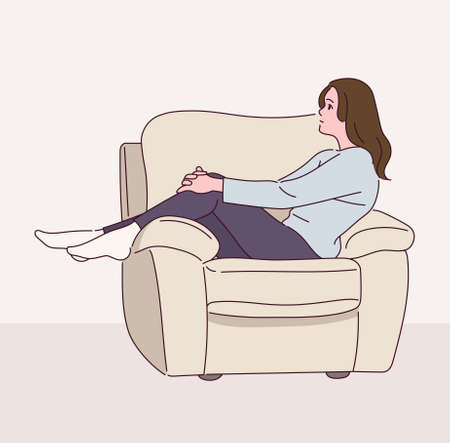 A woman is sitting sideways on the sofa.のイラスト素材