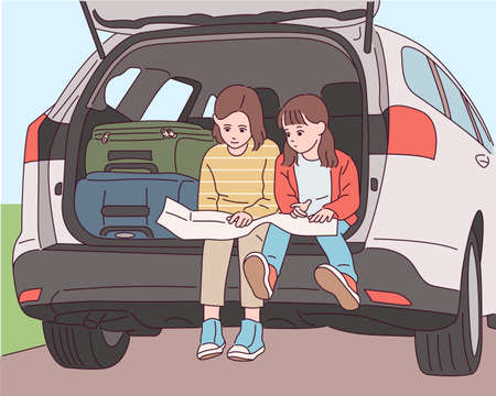Cute little sisters are sitting in the trunk behind the car and looking at the map.のイラスト素材