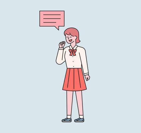 A girl in a school uniform is speaking. A speech bubble floats above her girl's head. flat design style minimal vector illustration.のイラスト素材
