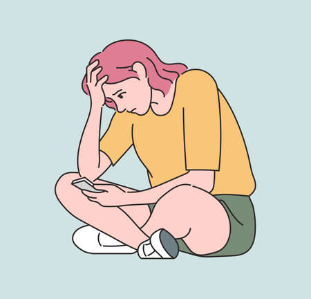 A woman is looking at her cell phone and has a serious expression. hand drawn style vector design illustrations.のイラスト素材