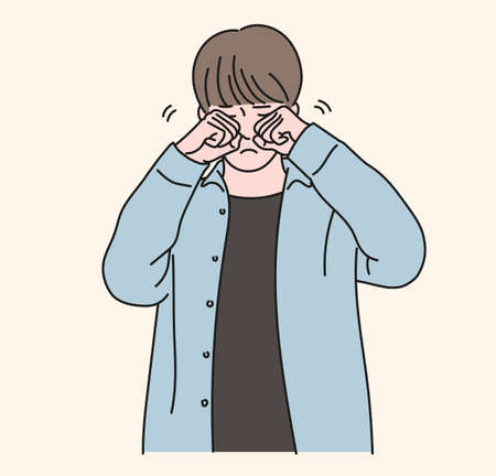 A boy is rubbing his eyes with both hands. hand drawn style vector design illustrations.のイラスト素材
