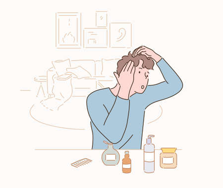 A man arranging beauty products in front of him and examining the condition of his hair.のイラスト素材