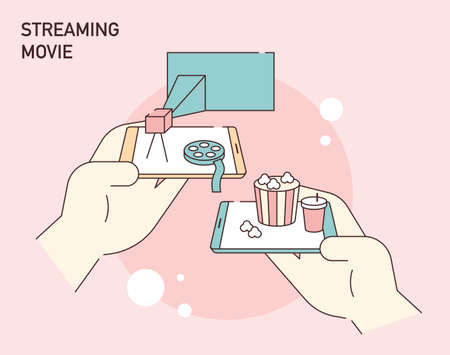 A hand holding a mobile phone and movie objects on a mobile screen. flat design style vector illustration.のイラスト素材