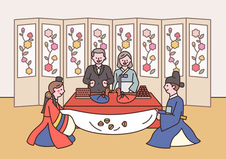 Korean traditional wedding. The bride and groom are sitting in front of their parents and listening to congratulations.のイラスト素材