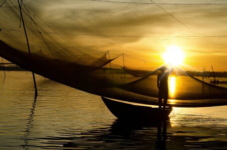 Man checking his dip-net in early morningのeditorial素材