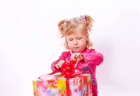 The joyful girl opens a box with a giftの写真素材