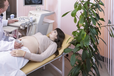  pregnant woman on inspection at the doctorの写真素材