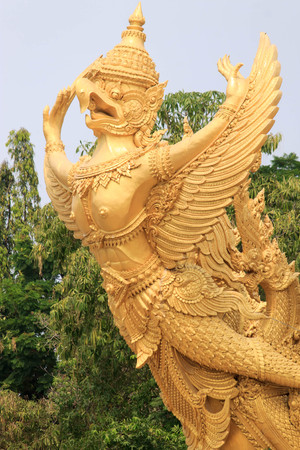 Big buddhist garuda infront of big candle in Ubon, Thailandの写真素材
