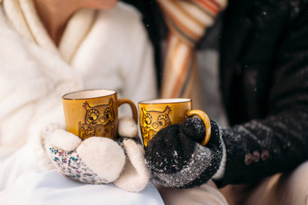 couple in love drinking tea in winterの写真素材